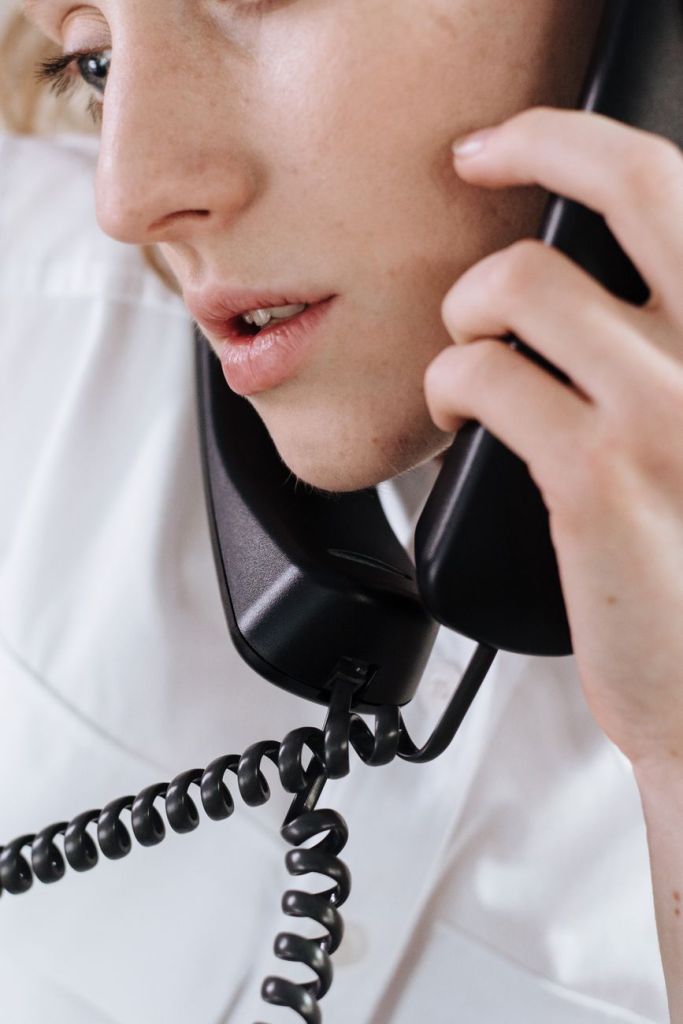 a woman having a phone call in close up photography