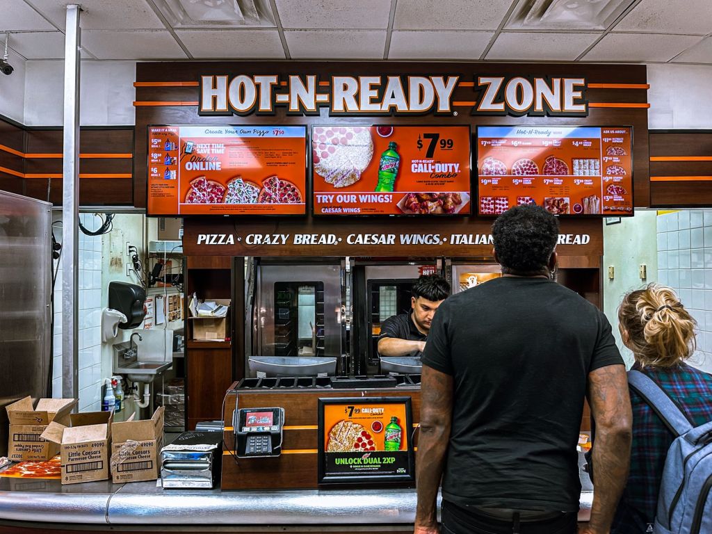 back view shot of people ordering on the counter