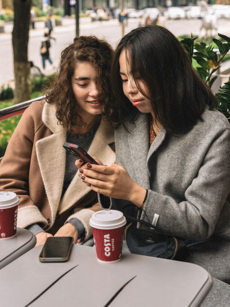 friends sharing a coffee at an outdoor cafe